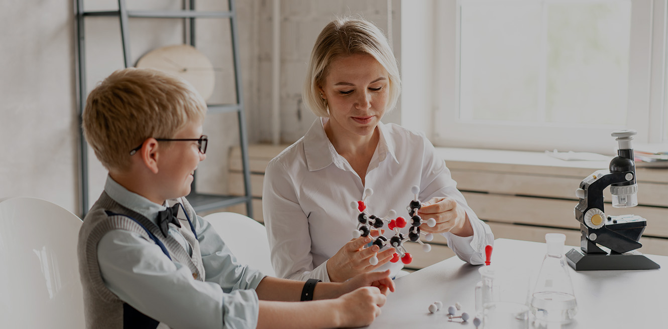 Female science tutor in Cincinnatti studying chemistry with student